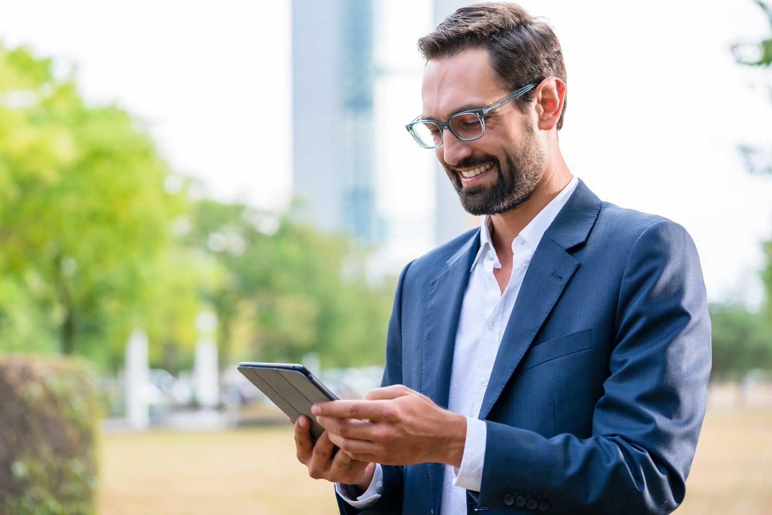 close-up-of-happy-businessman-looking-at-digital-tablet